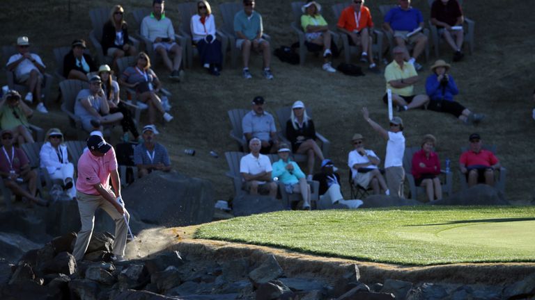 Dufner plays from the rocks on the 17th hole to save an unlikely par and force a play-off