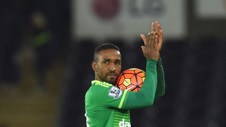 Jermain Defoe walks off with the match ball after his hat-trick at Swansea