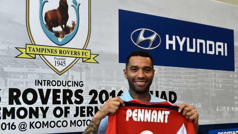 Former Arsenal and Liverpool winger Jermaine Pennant poses with his name on a jersey after the signing ceremony with Tampines Rovers in Singapore