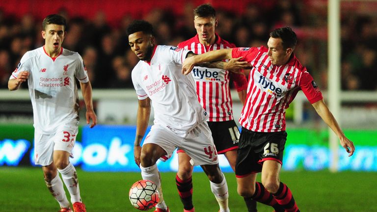 Jerome Sinclair of Liverpool (second left) holds off Jordan Tillson of Exeter City during the Emirates FA Cup third round match