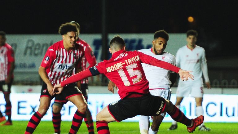 EXETER, ENGLAND - JANUARY 08:  Jerome Sinclair of Liverpool beats Jordan Moore-Taylor of Exeter City (15) to score their first and equalising goal during t