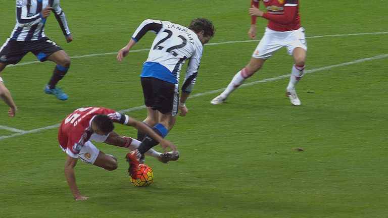 Daryl Janmaat falls under Jesse Lingard's challenge in the penalty box