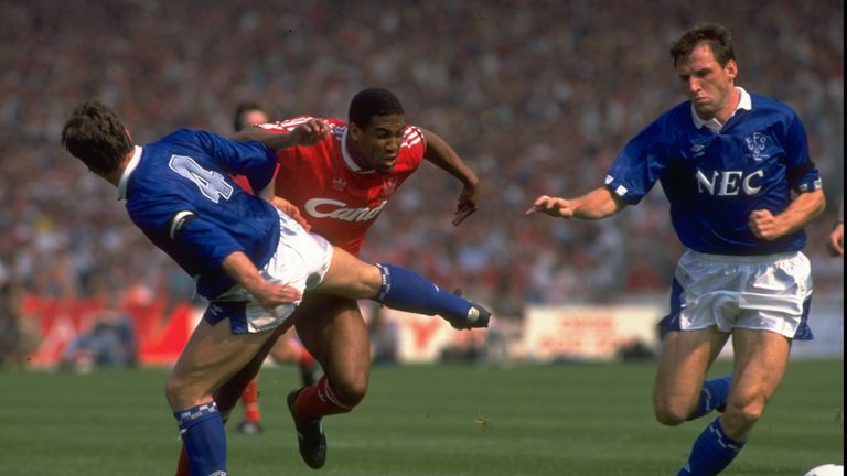 May 1989:  Kevin Ratcliffe (left) of Everton brings down John Barnes (centre) of Liverpool as Dave Watson (right) gains possession of the ball during the F