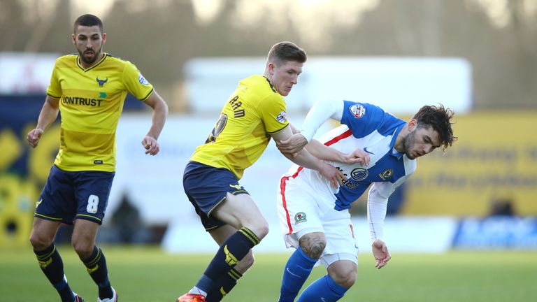 John Lundstram of Oxford and Blackburn's Tony Watt compete for the ball