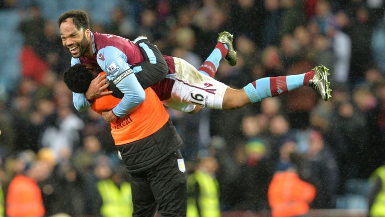 Aston Villa's English defender Joleon Lescott (top) celebrates after winning the match against Crystal Palace