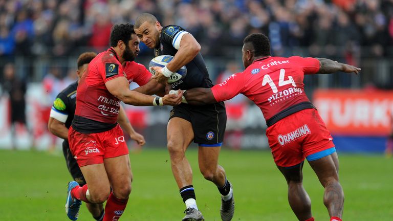 Jonathan Joseph of Bath is tackled by Toulon pair Maxime Mermoz (left) and Josua Tuisova