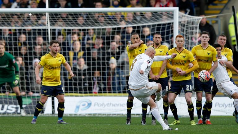 Oxford players form a wall as Swansea City's English midfielder Jonjo Shelvey takes a free kick during the FA Cup third-round match against Oxford United 