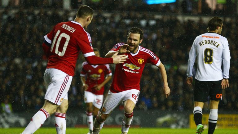 Juan Mata of Manchester United (8) celebrates with Wayne Rooney (10)