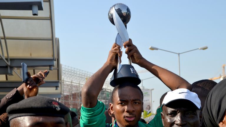 Nigeria's Kelechi Nwakali carries the Fifa Under-17 World Cup trophy on his head in the midst of a crowd