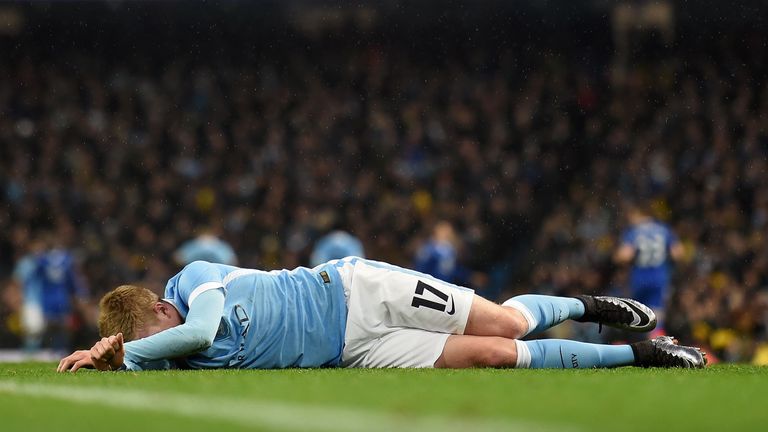 Manchester City's Belgian midfielder Kevin De Bruyne lies injured on the pitch before being stretchered off 