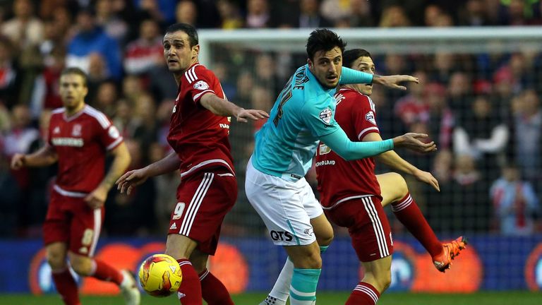 Kike (L) and Stewart Downing (R) of Middlesbrough challenge George Thorne of Derby County 