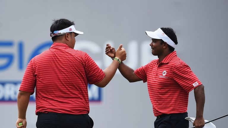 KUALA LUMPUR, MALAYSIA - JANUARY 16:  Kiradech Aphibarnrat of team Asia celebrates with S.S.P. Chawrasia during thee second day's foursome