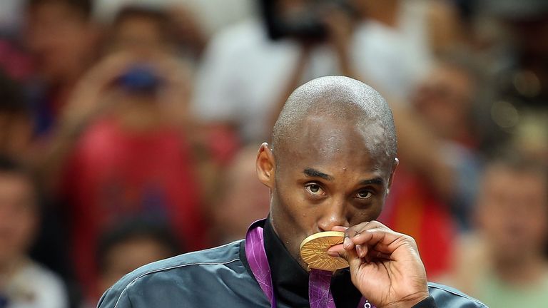 Kobe Bryant of United States kisses his gold medal after defeating China in the Men's Basketball gold medal game on Day 1