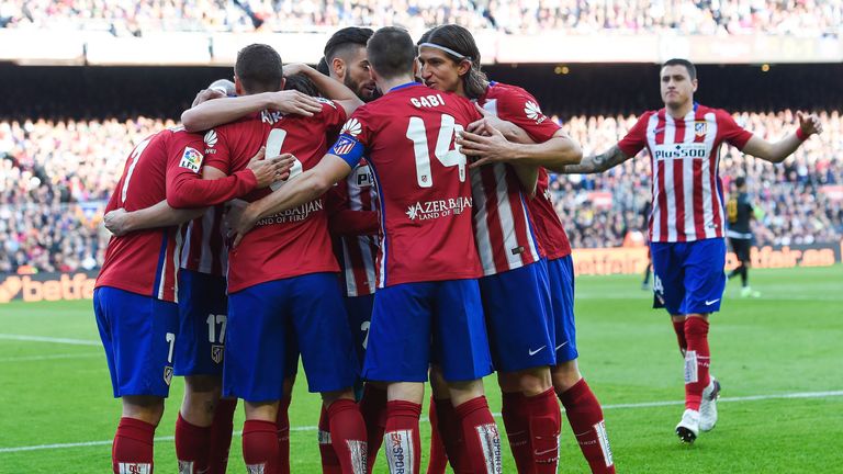 Atletico Madrid's midfielder Koke (2ndL) celebrates with teammates after scoring for Atletico against Barcelona