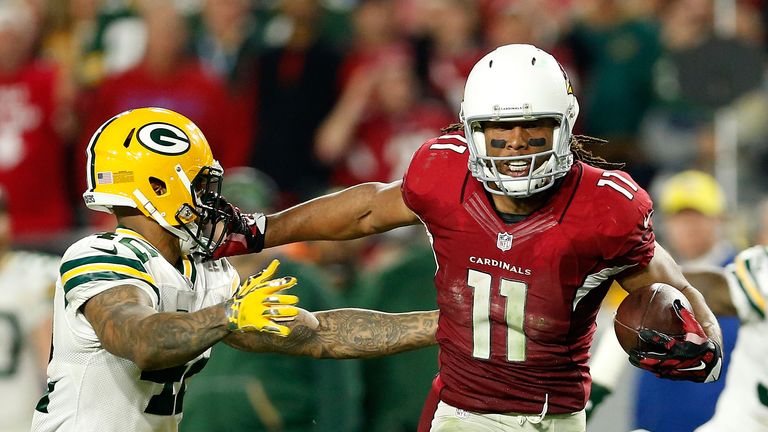 Larry Fitzgerald #11 of the Arizona Cardinals stiff arms strong safety Morgan Burnett #42 of the Green Bay Packers