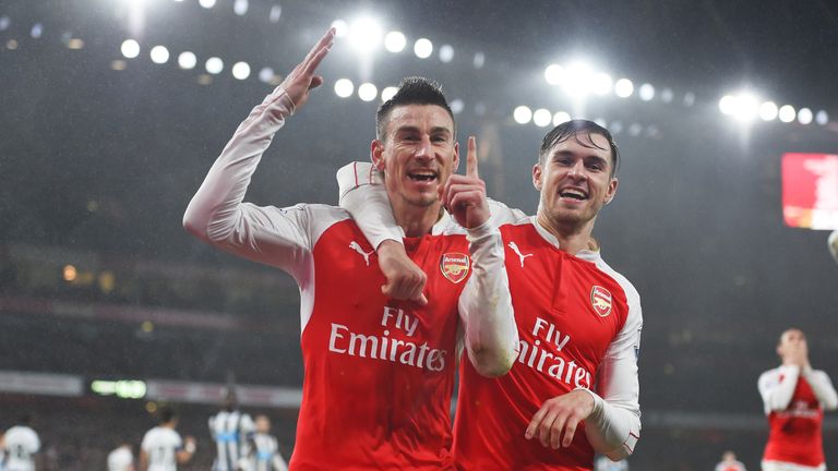 Laurent Koscielny (L) celebrates putting Arsenal 1-0 up against Newcastle, with his team mate Aaron Ramsey (R)