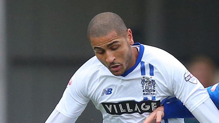 Bury's Leon Clarke (left) and Rochdale's Callum Camps compete for the ball during the Emirates FA Cup, second round match at the Spotland Stadium, Rochdale