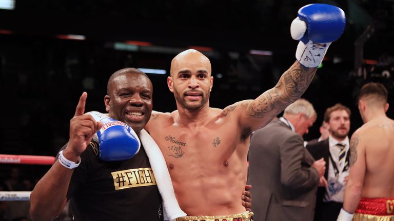 Leon McKenzie celebrates with father and trainer Clinton after beating Kelvin Young (background) 