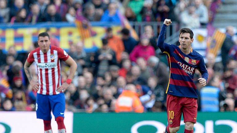 Barcelona's Argentinian forward Lionel Messi (R) celebrates his goal during the Spanish league football match FC Barcelona vs Club Atletico de Madrid
