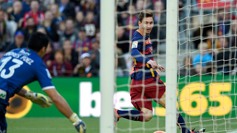 Barcelona's Argentinian forward Lionel Messi (R) scores a goal during the Spanish league football match FC Barcelona vs Granada CF at the Camp Nou