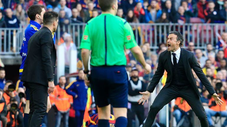 Barcelona's coach Luis Enrique (R) rages at the assistant referee after Filipe Luis' foul on Lionel Messi