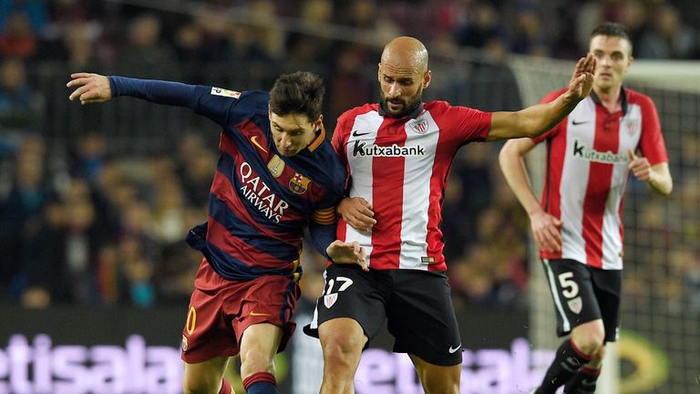 Lionel Messi is challenged by Mikel Rico at the Nou Camp