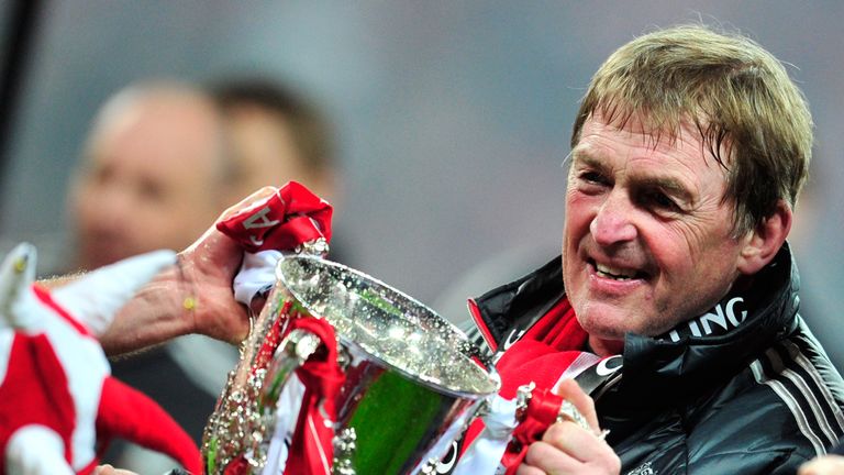Liverpool's manager Kenny Dalglish celebrates with the trophy after his team beat Cardiff City in the League Cup Final at Wembley in 2012