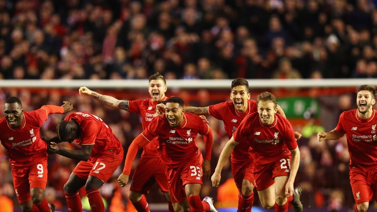 Liverpool players celebrate after Joe Allen scores the winning penalty against Stoke