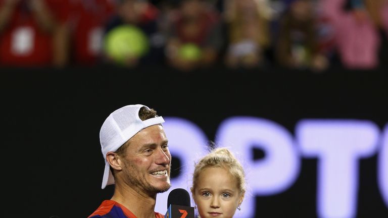 Lleyton Hewitt of Australia is interviewed on court with his children