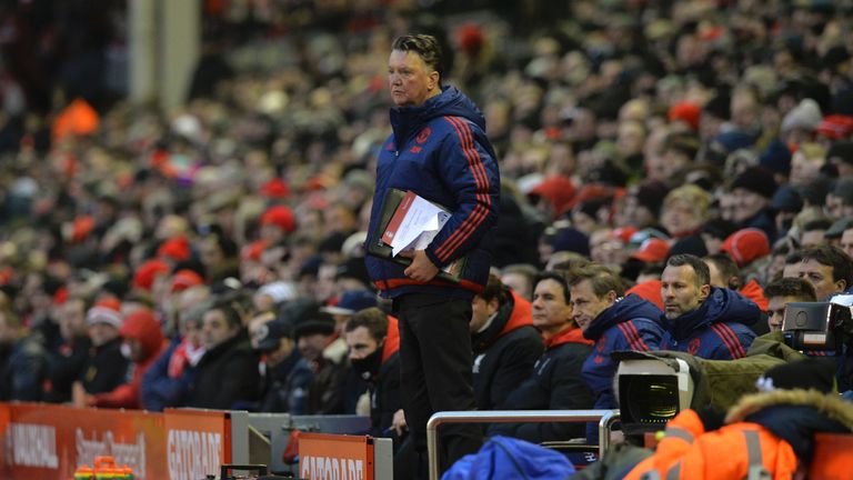 Manchester United manager Louis van Gaal stands in the dug-out during the English Premier League football match between Liverpool and Manchester United