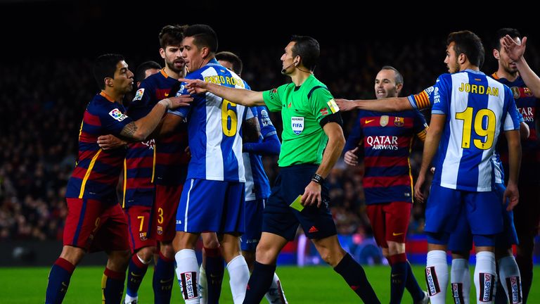 Luis Suarez argues with Espanyol players during their Copa del Rey encounter