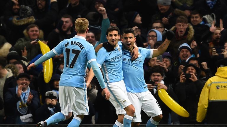 (R-L) Sergio Aguero of Manchester City is congratulated by teammates Jesus Navas and Kevin De Bruyne 