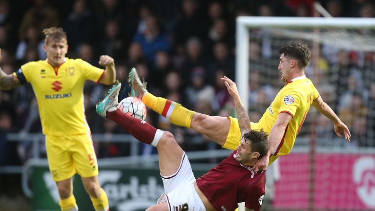 NORTHAMPTON, ENGLAND - JANUARY 09: Marc Richards of Northampton Town contests the ball with Joe Walsh of Milton Keynes Dons during The Emirates FA Cup Thir