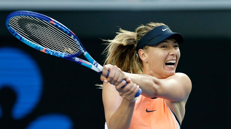 Maria Sharapova of Russia plays a backhand in her first round match against Nao Hibino of Japan during day one of the 2