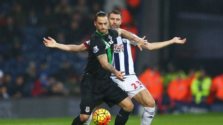 Marko Arnautovic of Stoke City and Gareth McAuley of West Bromwich Albion compete for the ball