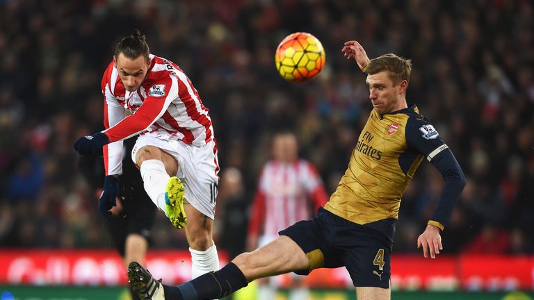 Marko Arnautovic of Stoke City is closed down by Per Mertesacker of Arsenal, Premier League