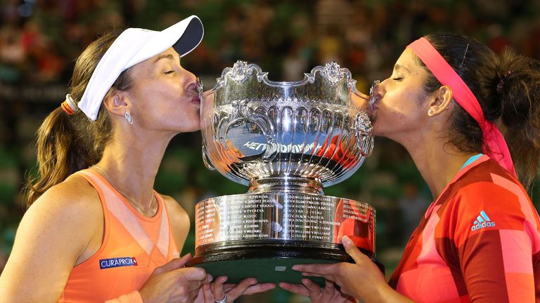 Martina Hingis and Sania Mirza celebrate with the trophy