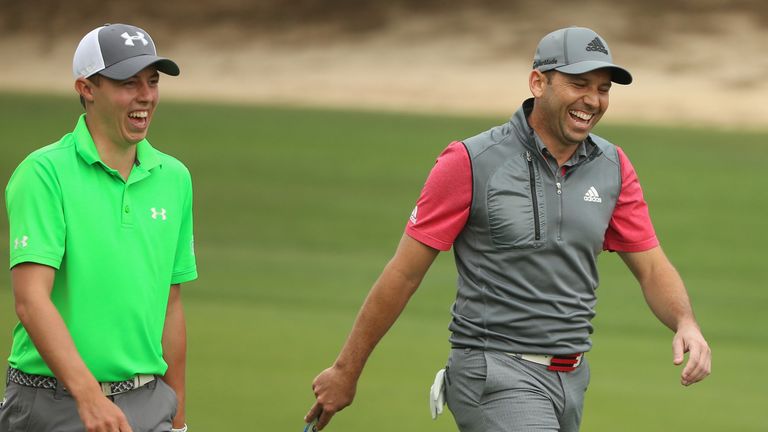 Matthew Fitzpatrick of England (left) and Sergio Garcia of Spain share a joke on the 11th hole during the first round