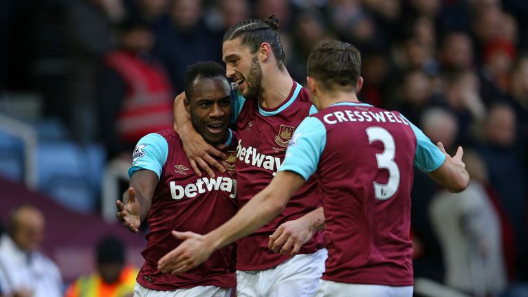 Michail Antonio (L) celebrates with Andy Carroll and Aaron Cresswell (R) after scoring the opening goal of the match between West Ham United and Liverpool