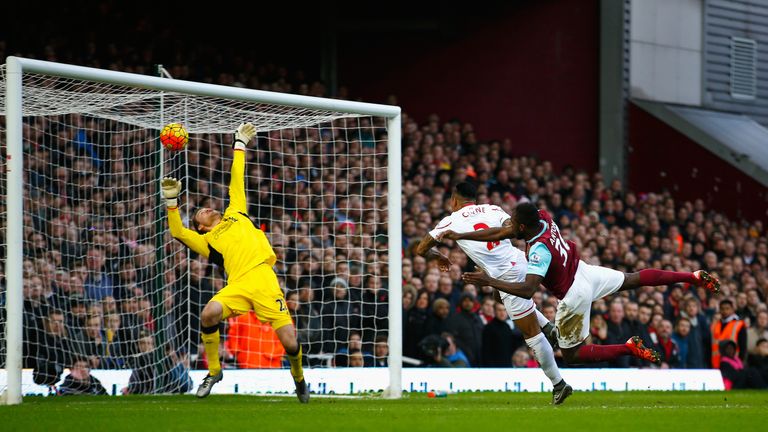 Michail Antonio (R) of West Ham United heads the ball past Liverpool goalkeeper Simon Mignolet (L) to score his team's first goal.