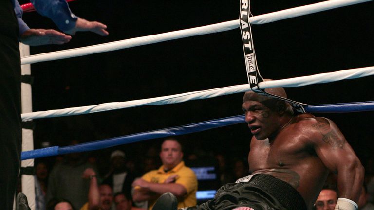 Former heavyweight champion Mike Tyson (L) sinks to the canvas after being pushed by Kevin McBride of Ireland in the sixth round 11 June 005 at the MCI Cen