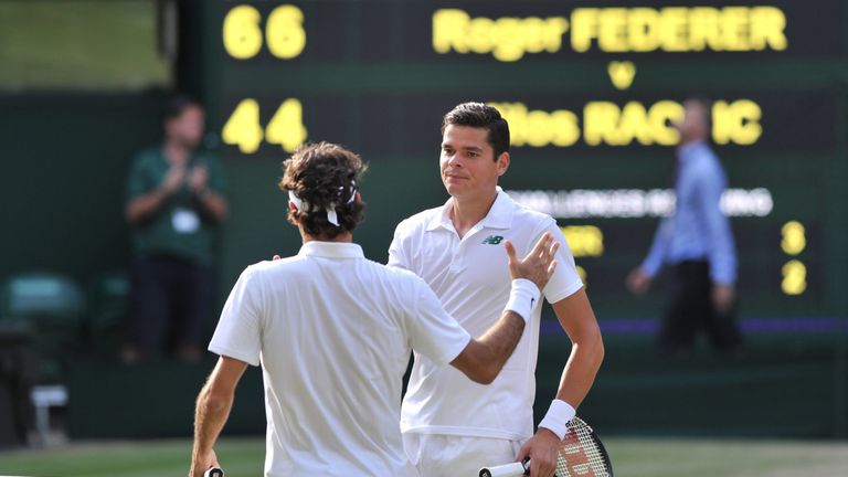 Switzerland's Roger Federer (L) shakes hands with Canada's Milos Raonic after the former won their men's singles semi-final match on day 11 of  the 2014 Wi