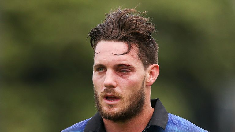 Mitchell McClenaghan of New Zealand leaves the field after being struck by a bouncer while batting for New Zealand against Pakistan