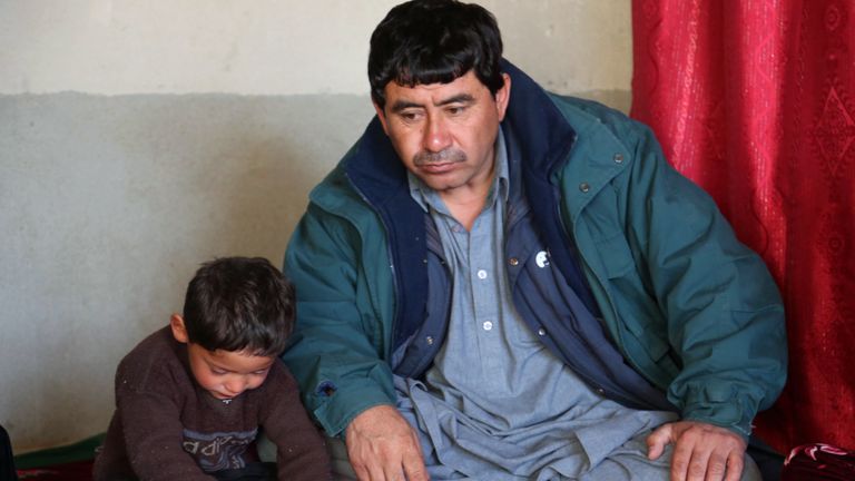Murtaza Ahmadi, 5, sits with his dad Muhammad Arif Ahmadi