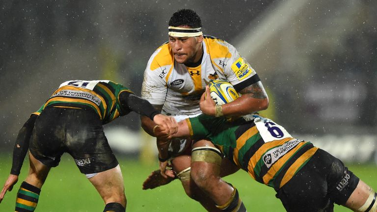 Nathan Hughes of Wasps is tackled by Lee Dickson and Tom Wood of Northampton Saints during their Aviva Premiership match