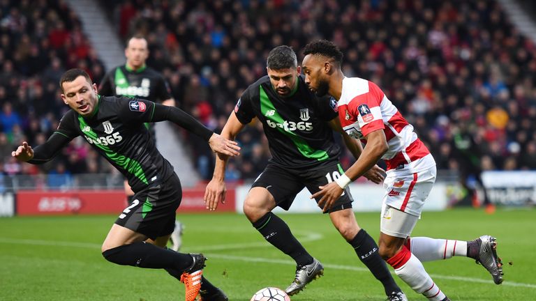 Nathan Tyson (R) of Doncaster Rovers competes for the ball against Jonathan Walters (C) and Phillip Bardsley (L)of Stoke City 