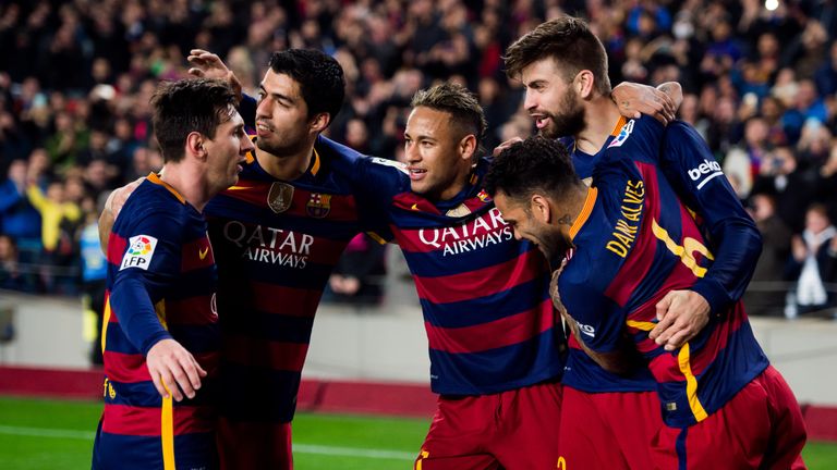 Lionel Messi, Luis Suarez, Neymar Santos Jr and Dani Alves of FC Barcelona celebrate with their teammate Gerard Pique (R)
