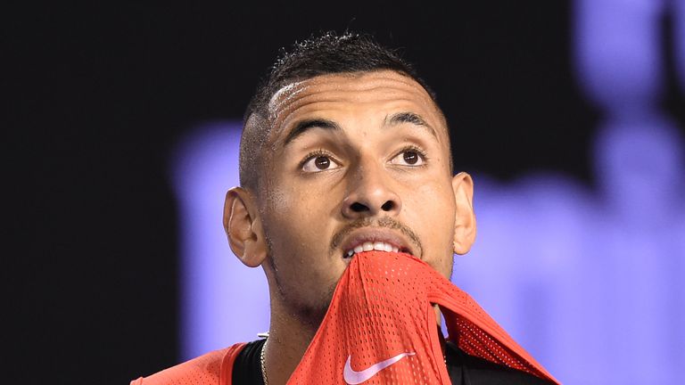 Australia's Nick Kyrgios holds his shirt in his mouth during his men's singles match against Czech Republic's Tomas Berdych 
