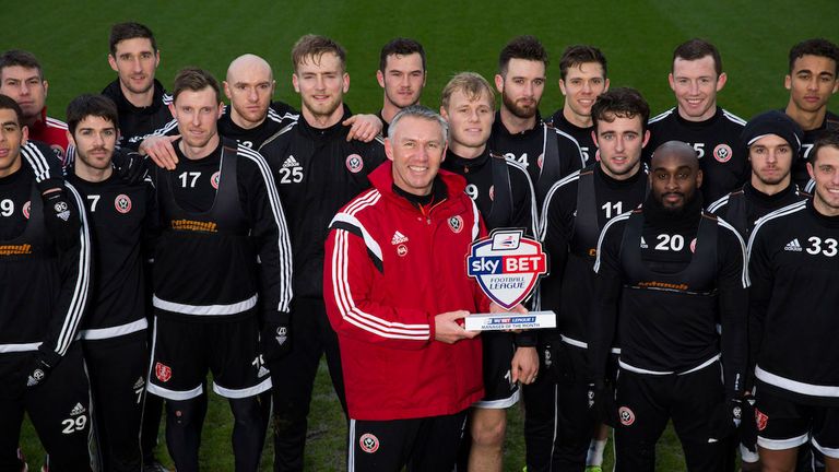 Nigel Adkins poses with his December award and the Sheffield United squad