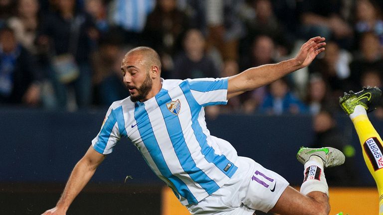 Malaga's Moroccan forward Nordin Amrabat (L) vies with Celta Vigo's goalkeeper Ruben Blanco during the Spanish  